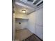 Functional laundry room equipped with tile flooring, utility connections, overhead light, and shelving at 2745 E Wood St, Phoenix, AZ 85040