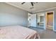 Bedroom featuring mirror closet doors, neutral paint, and a ceiling fan at 2823 W Banff Ln, Phoenix, AZ 85053