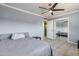This bedroom features tile floors, a ceiling fan, and mirrored closet doors at 2823 W Banff Ln, Phoenix, AZ 85053