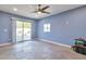 Bonus room features a sliding glass door, blue walls, custom flooring, and a ceiling fan at 2823 W Banff Ln, Phoenix, AZ 85053