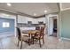 Dining area with a wooden table, tile floors, and adjacent to the kitchen at 2823 W Banff Ln, Phoenix, AZ 85053