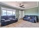 Spacious living room with tile floors, ceiling fan, and a comfortable seating area at 2823 W Banff Ln, Phoenix, AZ 85053