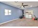 Well-lit utility room with blue walls, washer, dryer, shelving, and a ceiling fan at 2823 W Banff Ln, Phoenix, AZ 85053