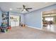Spacious utility room with washer, dryer, shelving, and ceiling fan connects to the living room at 2823 W Banff Ln, Phoenix, AZ 85053