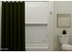 Bathroom features a tub with shower, white tile, and toilet at 3009 N 97Th Dr, Phoenix, AZ 85037
