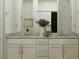 Bathroom vanity with double sinks, granite countertop, and white cabinets at 3009 N 97Th Dr, Phoenix, AZ 85037