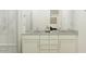 Elegant bathroom vanity with double sinks and granite countertop, complemented by stylish fixtures and ample storage at 3009 N 97Th Dr, Phoenix, AZ 85037