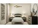 Charming bedroom with a cozy bed, decorative wall art, and stylish nightstands, creating a relaxing ambiance at 3009 N 97Th Dr, Phoenix, AZ 85037