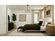 A calming bedroom featuring a large bed, stylish light fixture, and decorative art for a peaceful retreat at 3009 N 97Th Dr, Phoenix, AZ 85037