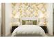 Well-lit bedroom with a comfortable bed, stylish nightstands, and decorative wallpaper for a welcoming space at 3009 N 97Th Dr, Phoenix, AZ 85037