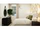 Stylish bedroom featuring natural light, modern decor, and a comfortable bed for a serene atmosphere at 3009 N 97Th Dr, Phoenix, AZ 85037