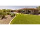 Expansive backyard with artificial turf, a sparkling pool, and a covered patio offers relaxation at 3119 E Bellflower Dr, Gilbert, AZ 85298