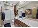 Bathroom features neutral colors, a shower-tub combo, and unique art over a granite countertop at 3119 E Bellflower Dr, Gilbert, AZ 85298