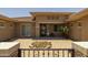 Home's entry courtyard featuring decorative iron gate and lush landscaping at 3119 E Bellflower Dr, Gilbert, AZ 85298