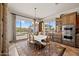 Bright dining room with a large window overlooking the backyard and custom built-in cabinets at 3119 E Bellflower Dr, Gilbert, AZ 85298