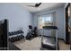Well-lit workout room with an exercise bike and a treadmill overlooks the front yard at 3119 E Bellflower Dr, Gilbert, AZ 85298