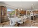 Open concept kitchen with an island, custom cabinetry, stainless steel appliances, and adjacent dining area at 3119 E Bellflower Dr, Gilbert, AZ 85298