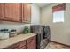 Laundry room features wood cabinets and a front loading washer and dryer for added convenience at 3119 E Bellflower Dr, Gilbert, AZ 85298