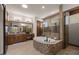 Luxurious main bathroom with a soaking tub, tiled shower, and a double vanity with framed mirror at 3119 E Bellflower Dr, Gilbert, AZ 85298