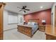 Spacious main bedroom features a wood bed frame, stylish lamps, and an elegant ceiling fan at 3119 E Bellflower Dr, Gilbert, AZ 85298