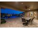 Spacious outdoor dining area with a view of the pool and landscape, providing a serene and elegant setting at 3119 E Bellflower Dr, Gilbert, AZ 85298