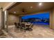 Covered outdoor dining area leading to a luxurious pool with rock features, perfect for entertaining guests at 3119 E Bellflower Dr, Gilbert, AZ 85298