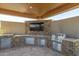 The outdoor kitchen features a stainless steel grill, sink, and TV at 3119 E Bellflower Dr, Gilbert, AZ 85298