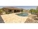 Lush backyard featuring a beautiful pool with a tanning ledge and mature landscaping, perfect for relaxation at 3119 E Bellflower Dr, Gilbert, AZ 85298