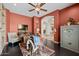 Comfortable sitting room with custom built-ins, tv, and access to another room through an arched doorway at 3119 E Bellflower Dr, Gilbert, AZ 85298