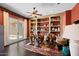 Inviting sitting room with custom built-ins, ceiling fan, and french doors leading to outdoor space at 3119 E Bellflower Dr, Gilbert, AZ 85298