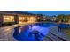 Stunning pool featuring a bar table, lush landscaping, and an inviting atmosphere for relaxation and entertaining at 3119 E Bellflower Dr, Gilbert, AZ 85298