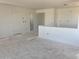 An unfinished living room displaying its spacious layout and bright, neutral walls at 32016 N Pony Express Rd, San Tan Valley, AZ 85143