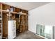 Unfinished room features water heater, exposed wood beams and a window at 3408 N 69Th Dr, Phoenix, AZ 85033