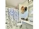 A clean bathroom with a shower-tub combo, stylish vanity, and decorative wall art creates a relaxing space at 3408 N 69Th Dr, Phoenix, AZ 85033