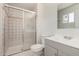 Bathroom featuring tiled shower with sliding glass door, vanity, and updated fixtures at 3408 N 69Th Dr, Phoenix, AZ 85033