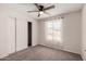 Bedroom features carpet, ceiling fan, window, and sliding closet doors at 3408 N 69Th Dr, Phoenix, AZ 85033