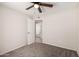 Bedroom boasts neutral carpet, ceiling fan, and doorway to other rooms at 3408 N 69Th Dr, Phoenix, AZ 85033