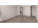Neutral bedroom featuring carpeted floors, closet space, and easy access to an en-suite bathroom at 3408 N 69Th Dr, Phoenix, AZ 85033