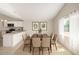 Bright dining area connected to the kitchen features stylish chairs and a modern light fixture at 3408 N 69Th Dr, Phoenix, AZ 85033
