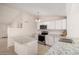 Open kitchen featuring granite countertops, white cabinetry, and a functional island for meal preparation at 3408 N 69Th Dr, Phoenix, AZ 85033