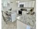 The kitchen features white cabinets, stainless steel appliances, granite countertops, and seating for modern living at 3408 N 69Th Dr, Phoenix, AZ 85033