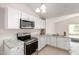 Modern kitchen with stainless steel appliances, white cabinets, and granite countertops with ample counter space at 3408 N 69Th Dr, Phoenix, AZ 85033