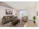 Inviting living room features neutral tones, a comfortable seating arrangement, and ample natural light at 3408 N 69Th Dr, Phoenix, AZ 85033