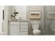 Clean bathroom with a vanity, toilet, framed art and a glass-enclosed shower at 36550 W Maddaloni Ave, Maricopa, AZ 85138