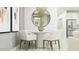 Chic dining area features a round table, white chairs, and an elegant mirror at 36550 W Maddaloni Ave, Maricopa, AZ 85138