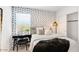 Modern bedroom featuring a unique wallpaper, stylish decor, and a comfortable, inviting space at 36600 W Maddaloni Ave, Maricopa, AZ 85138