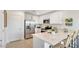 Contemporary kitchen with stainless steel appliances, white cabinetry, and breakfast bar seating at 36600 W Maddaloni Ave, Maricopa, AZ 85138
