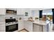 Modern kitchen featuring stainless steel appliances, sleek countertops, and an open layout with outdoor views at 36600 W Maddaloni Ave, Maricopa, AZ 85138