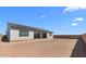 Expansive backyard with potential for landscaping and outdoor living, featuring a stucco home and privacy fence at 37695 W Santa Maria St, Maricopa, AZ 85138