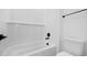 Bright bathroom features a white bathtub, white subway tile, and black hardware at 37695 W Santa Maria St, Maricopa, AZ 85138